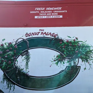 the donut palace logo painted on the side of a building