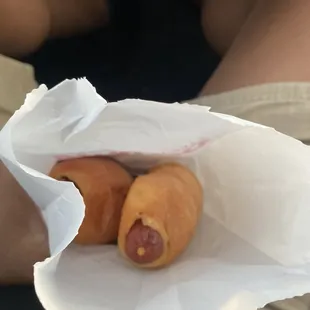 two hot dogs wrapped in paper