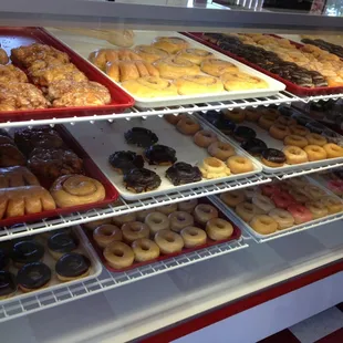 a variety of donuts in a display case