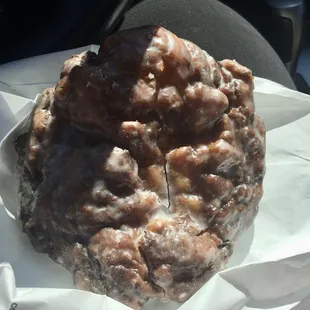 The larger than life apple fritter. Compare it to the size of my leg that it's sitting on!