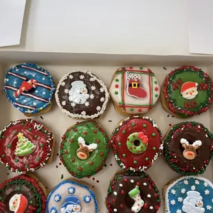 a variety of decorated donuts in a box