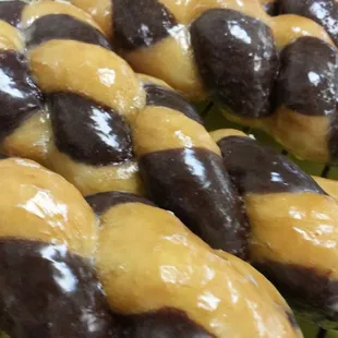 chocolate and vanilla donuts on a cooling rack