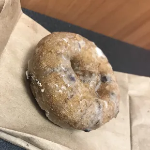 a doughnut on a brown paper bag