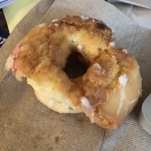 a glazed donut with a bite taken out of it