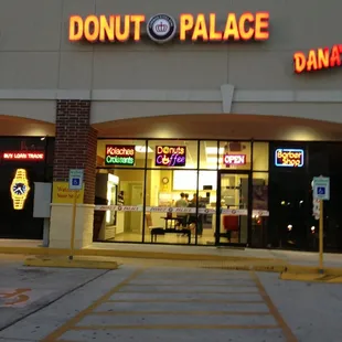 a donut palace storefront at night
