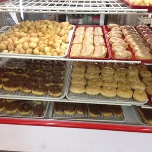 a variety of donuts in a display case