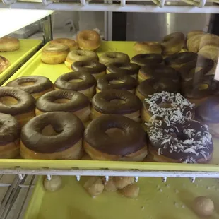 a variety of donuts in a display case