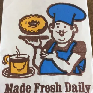 a man holding a donut and a cup of coffee