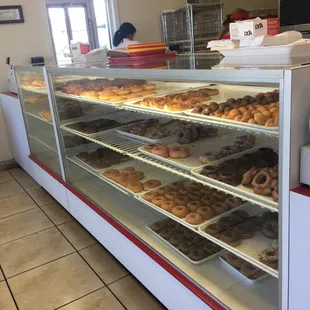 a variety of donuts in a display case