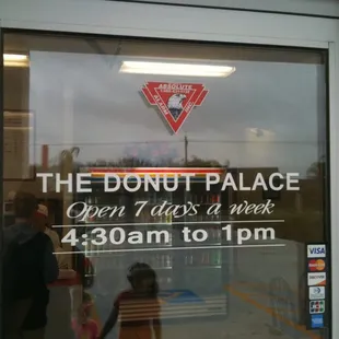 a reflection in the window of a donut palace