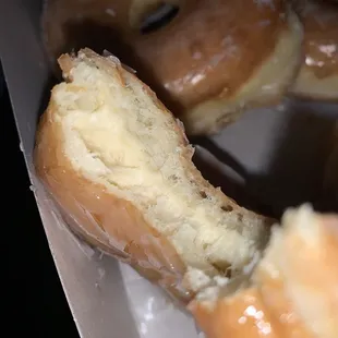 a half eaten donut in a box