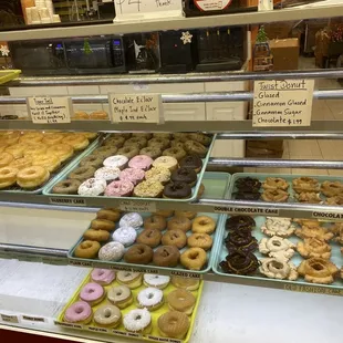 a variety of donuts in a display case