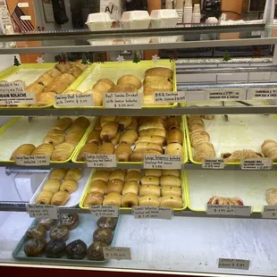a variety of donuts in a display case