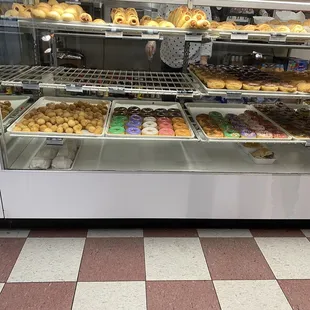 a variety of donuts in a display case