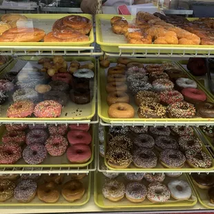 a variety of donuts in a display case