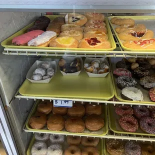 a variety of donuts in a display case