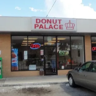 a car parked in front of a donut palace