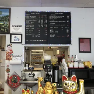 a chinese restaurant counter with a menu on the wall