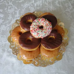 a plate of donuts with sprinkles