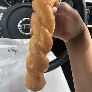 a person holding a donut in their hand