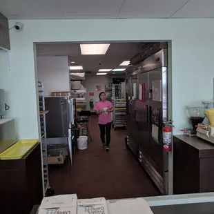 a woman standing in a commercial kitchen