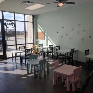 a woman mopping the floor in a donut shop