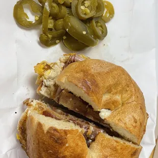 a half eaten sandwich and pickles