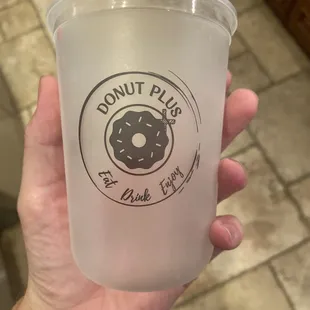 a hand holding a plastic cup