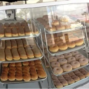 a variety of donuts in a display case