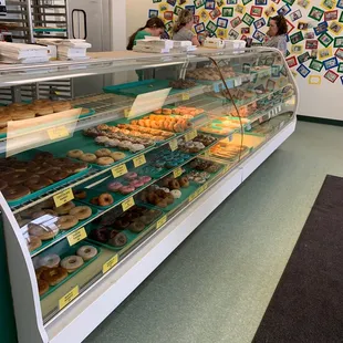 a display case with a variety of donuts