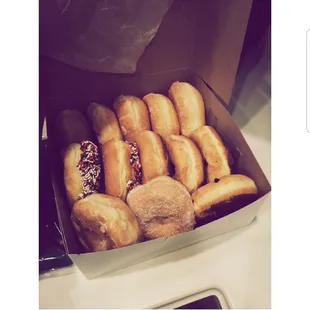 a box of doughnuts with sprinkles