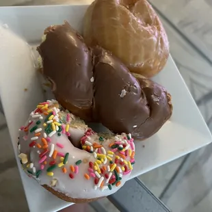 Chocolate twist, raspberry jelly, and cake donut with sprinkles