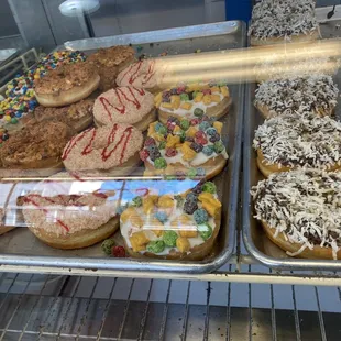 a variety of donuts in a display case