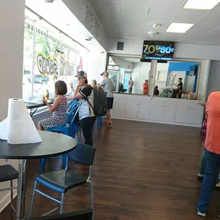 Window seating, donuts in hand.