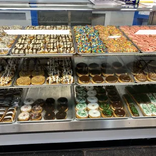 a variety of donuts in a display case