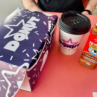 a cup of coffee and a box of donuts