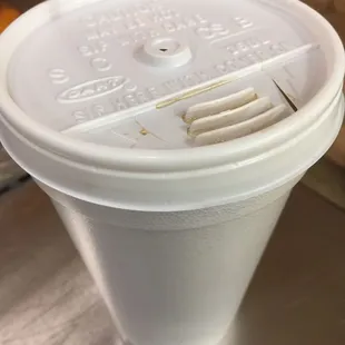 a plastic cup with a fork sticking out of it