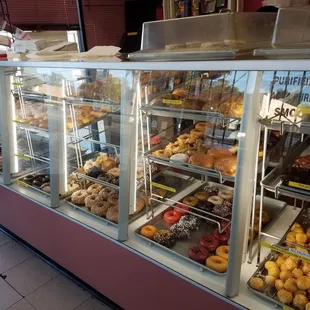 a variety of donuts in a display case