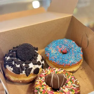 three different flavored donuts in a box