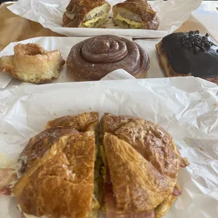 Bacon egg and cheese croissant, old fashion donut, cinnamon roll, and chocolate chip donut