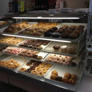 a variety of donuts in a display case