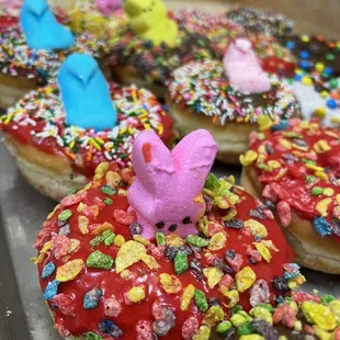 a variety of sprinkle covered donuts
