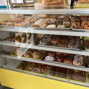 a display case filled with various types of donuts