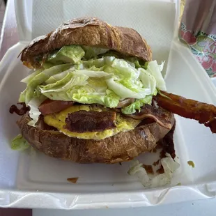 Croissant! Egg, ham, bacon, cheese, lettuce, tomatoes, and onions! Avocado and jalapeños!