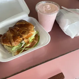 Croissant ham and cheese sandwich and strawberry banana smoothie