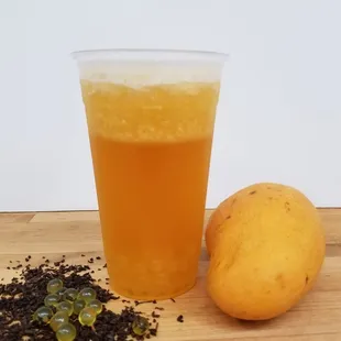 Mango tea with mango popping pearls. Made to order!