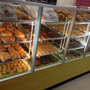 a variety of donuts in a display case