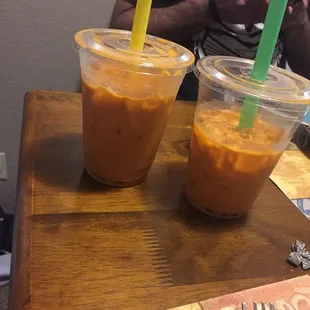 two cups of iced coffee on a table