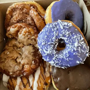 Cinnamon roll, caramel apple fritter, Nutella with banana, taro, taro with coconut and Bavarian cream