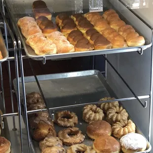 various types of donuts in a display case